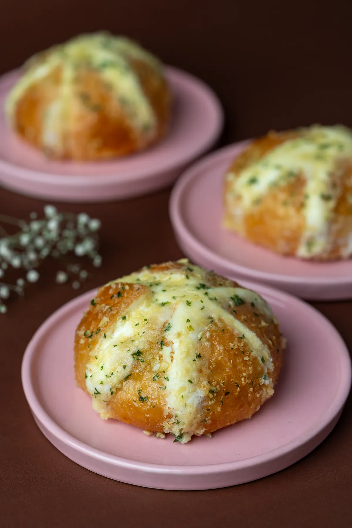 Korean buns at Tessori — soft buns filled with cream cheese and topped with garlic butter and parsley