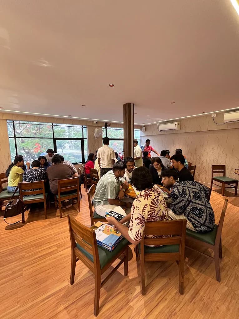 A full house at Tessori — groups around tables playing board games on a busy afternoon